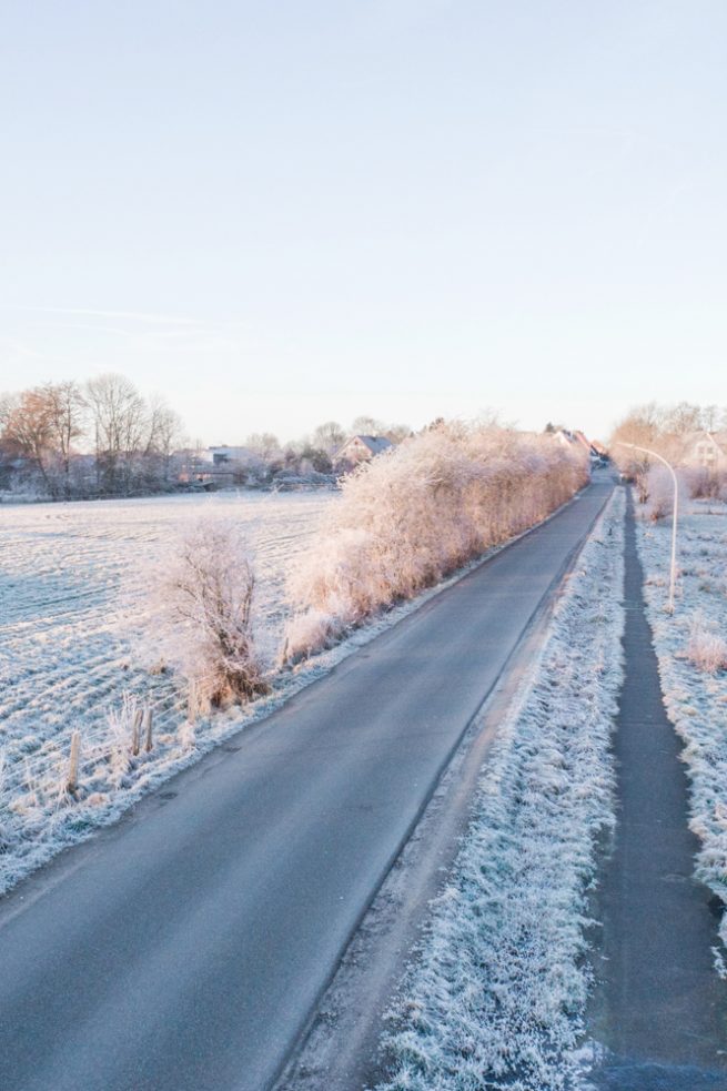 Drohnenfotografie in Schleswig-Holstein über einem Feld und Seenlandschaft bei Schnee
