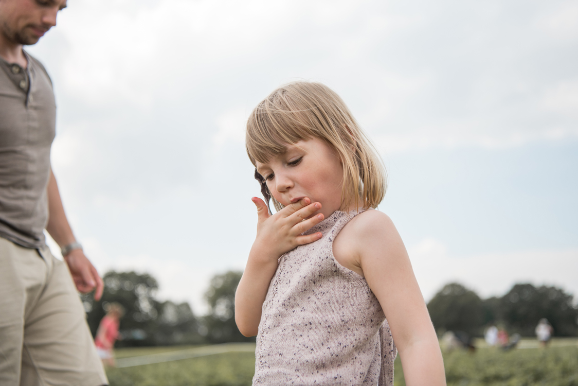 Kidsfotografie Lifestylefotografie in Hamburg für Social Media Familie pflückt Erdbeeren im Erdbeerfeld
