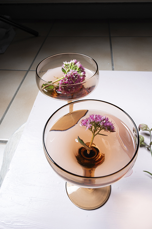 Editorial tableware still life featuring glassware with floral details, styled for hospitality and lifestyle brands