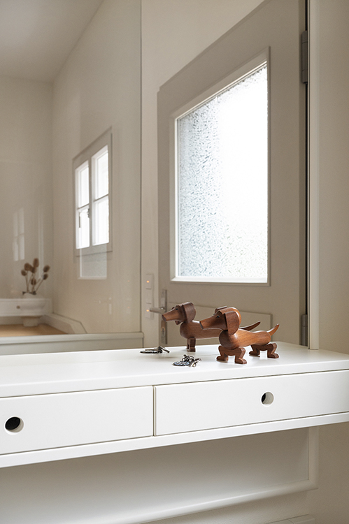 Interior detail showing custom wooden shelving, warm light and crafted surfaces