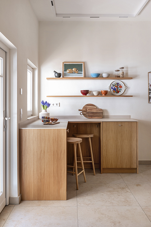Residential kitchen interior with custom wooden cabinetry, natural light and calm material palette, photographed for interior studios and carpentry